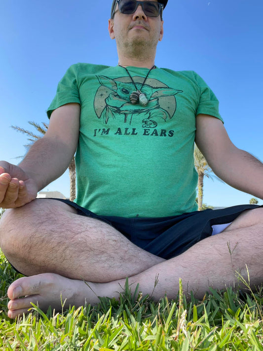 Man meditating in grass