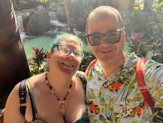 A Man and Woman smiling with a lagoon behind them