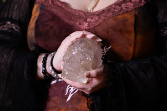 A Woman holding a Clear Quartz Crystal Skull