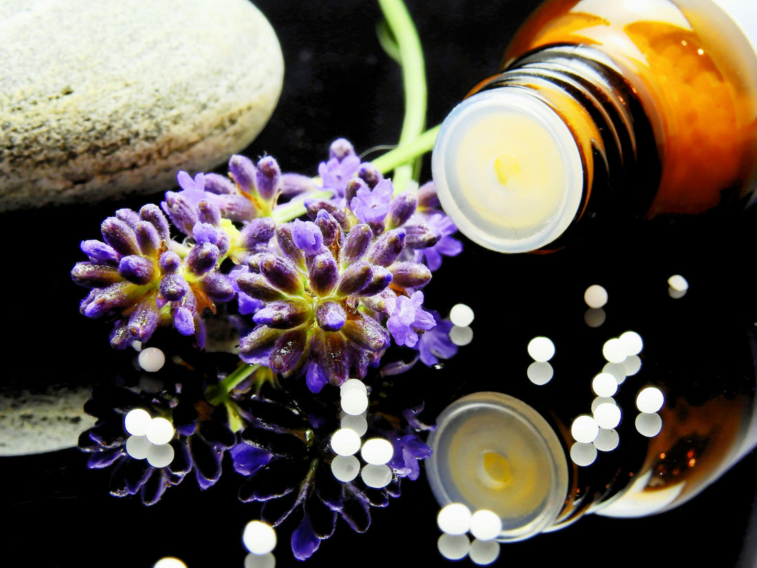 Lavender Flowers next to a toppled over essential oil bottle